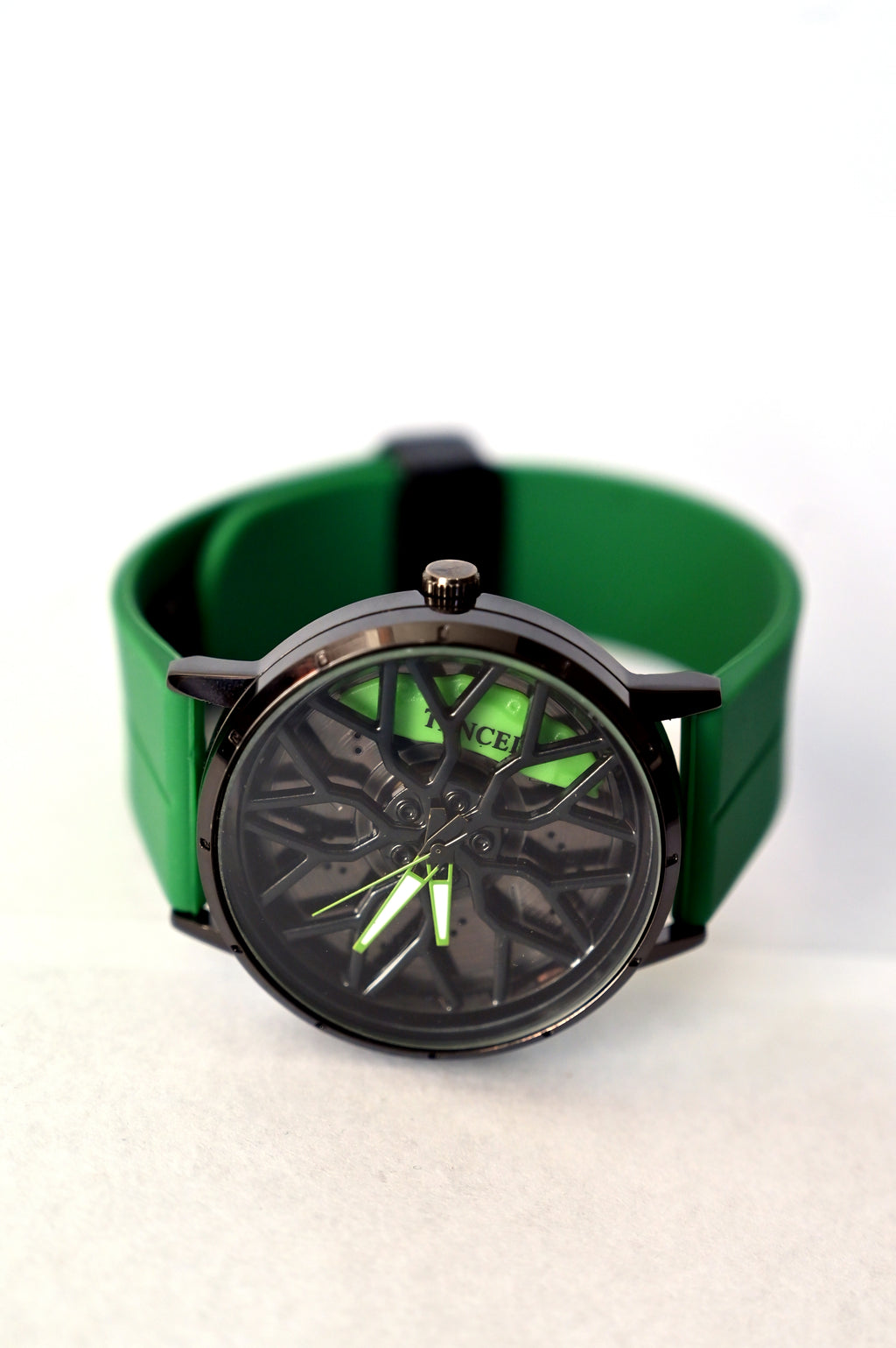 Green wristwatch with black case on a white background